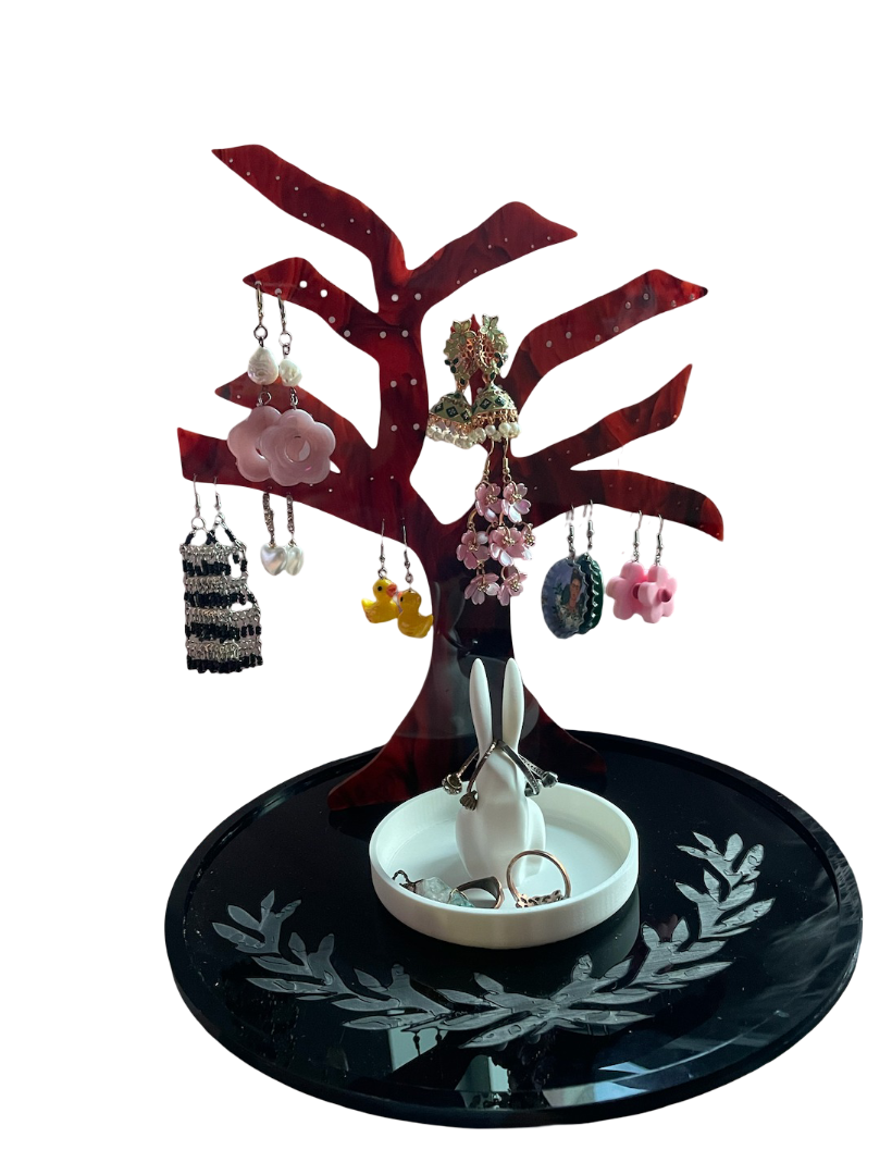 Rabbit tree earring holder being used with earrings hanging from the branches